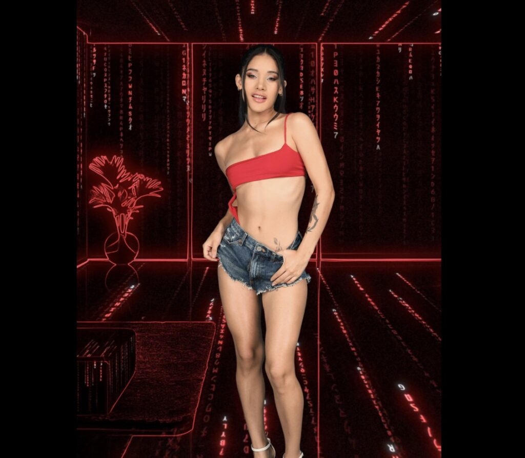 Latina VR pornstar Carolina Guerrero posing in denim shorts and skimpy red top.